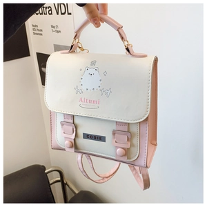 Detail of pink and beige patchwork backpack featuring a cute puppy illustration