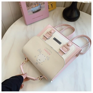 Detailed view of pink and beige mini backpack with cute animal print on marble surface