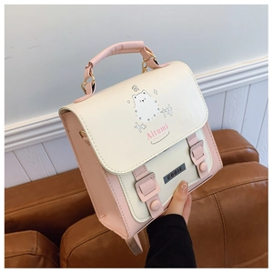 Close-up of Aitumi handbag featuring cartoon animal illustrations and leather texture