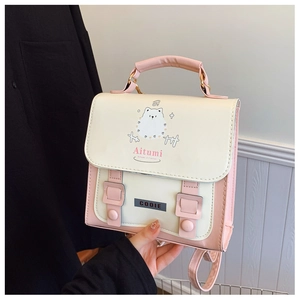 Close-up of pink faux leather backpack with white Samoyed cartoon and adjustable straps