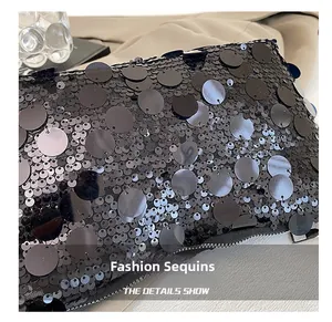 Close-up of black sequin layering craftsmanship and zipper detail on the shoulder bag