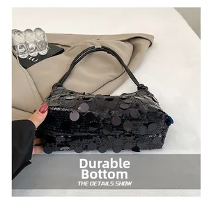 Detail of durable wear-resistant bottom on black sequin shoulder bag with chain strap