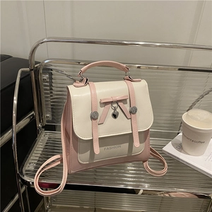 Pink and beige faux leather backpack with ribbon bow and silver heart pendant