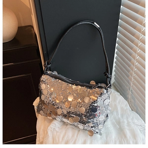Macro detail of sparkly silver sequins on a stylish shoulder bag with black strap