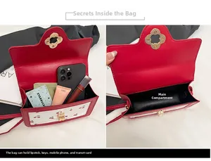 Detail of red leather crossbody bag showing internal compartments and cherry print pattern