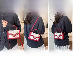 Detail view of mini white leather bag with cherry prints showing three carrying styles