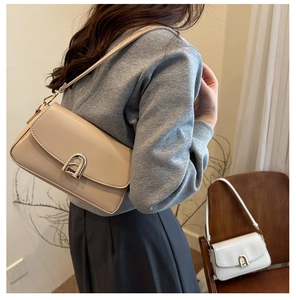 Détail du sac bandoulière beige minimaliste avec boucle en fer à cheval argentée
