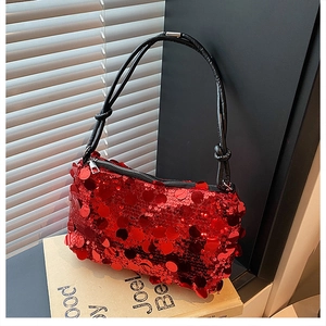 Close-up of red sequin small square bag with luxury metallic texture and zipper detail