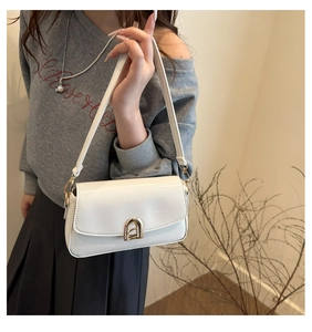Gros plan d'un sac baguette en cuir PU blanc avec boucle dorée porté par un mannequin