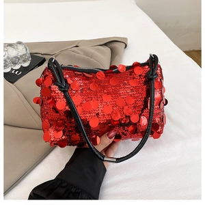 Detailed shot of vibrant red sequin embroidery on a stylish mini shoulder bag with black strap