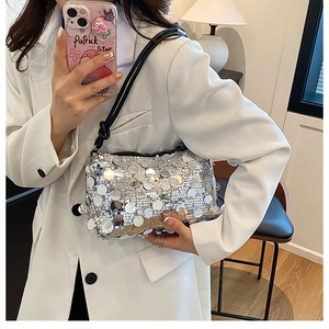 Detail shot of silver sequined handbag with shimmering metallic round discs and adjustable strap