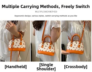Close-up of cream cherry print shell bag showing handheld, shoulder, and crossbody styles
