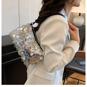 Detail of silver sequin shoulder bag with round mirror discs and woven knotted strap