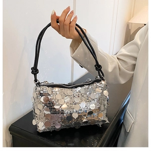 Detailed view of silver sequin shoulder bag with metallic shine and black cord strap