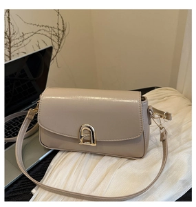 Vue détaillée du petit sac carré beige en similicuir avec un fermoir en métal doré chic