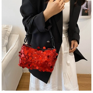 Chic red sequin shoulder bag style on model with black blazer and white pleated skirt