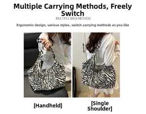 Détail du sac cabas zébré porté à la main et à l'épaule pour un style décontracté