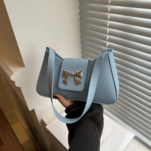 Chic light blue PU leather saddle bag with silver bow buckle, stylish shoulder armpit bag
