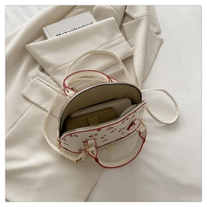 Detail view of cherry print bucket bag interior showing capacity for phone and wallet