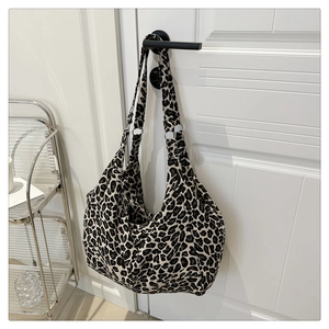 Détail du sac hobo avec toile à imprimé léopard et anneaux métalliques argentés