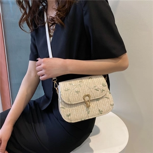 Chic beige straw saddle bag with green leaf embroidery and gold horseshoe metal lock