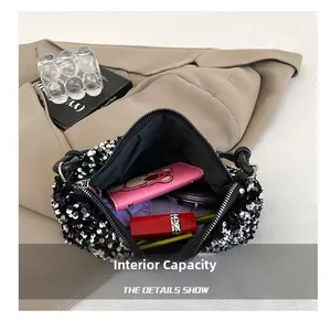 Detail view showing internal capacity of black sequin shoulder bag with essentials
