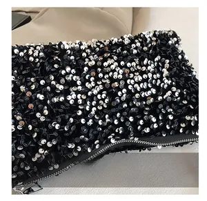 Close-up of black sequin baguette bag showing detailed texture and silver metal zipper