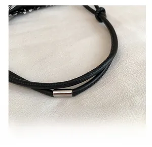 Detailed close-up of high-quality black leather shoulder strap with polished silver buckle
