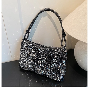Close-up of black and silver sequins on crossbody bag with knotted rope strap detail