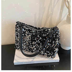 Close-up of shimmering black sequins on a shoulder bag with knotted strap detail