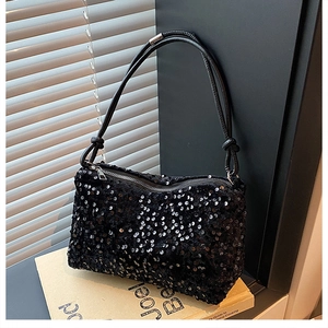 Detail of black sequined crossbody bag with woven rope strap and silver metal zipper