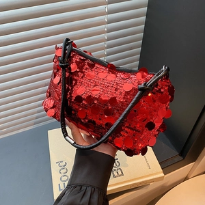 Sparkly red sequin baguette bag with black handles and elegant knotted shoulder strap