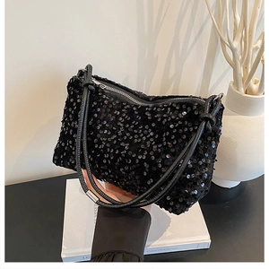 Close-up of black sequin shoulder bag with silver zipper and leather rope straps