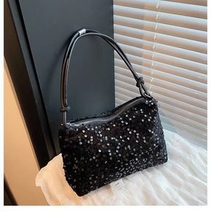 Detailed view of the sparkling black sequin texture and sleek zipper on the shoulder bag
