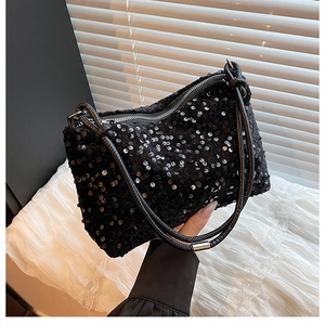 Detail shot of the sequined black shoulder bag with dual cylindrical leather handles
