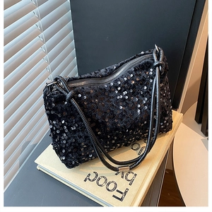 Close-up of stylish black sequin shoulder bag featuring a metallic zipper and delicate strap