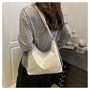 Detail view of jacquard pattern hobo bag with adjustable strap on female model