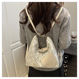 Detail of silver-grey jacquard handbag with beige leather patch and slim shoulder straps