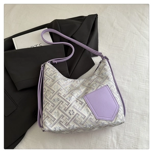 Detail of silver brocade texture with floral patterns and lavender leather accents