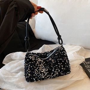 Sparkly black sequin crossbody bag with thin knotted shoulder strap and top zipper closure