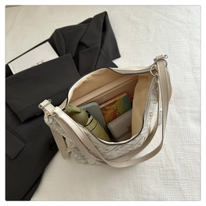 Detail view of cream white embroidered handbag with ample space for daily essentials