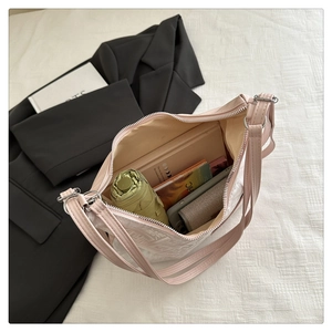 Pink crossbody bag interior showing storage space for phone, umbrella and notebook