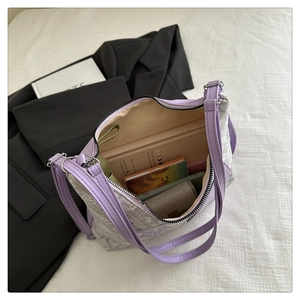 Detail showing high-capacity interior of purple embroidered tote bag for books and magazines