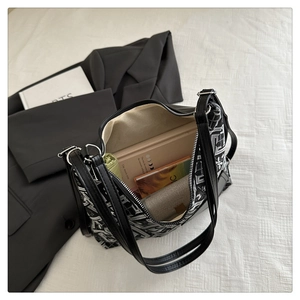 Top-down view of a half-moon jacquard bag interior showing spacious storage and items
