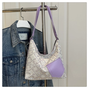 Detailed view of lavender jacquard handbag with geometric patterns and leather pocket
