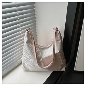 Detail of floral jacquard tote bag featuring premium leather pocket and sleek shoulder strap