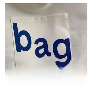 Detailed macro view of heavy canvas fabric texture and blue printed letter on the tote bag