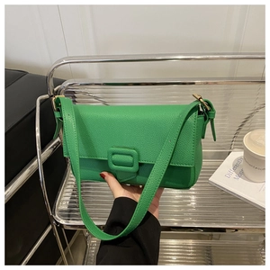 Detail view of green litchi grain leather shoulder bag with matching square buckle finish
