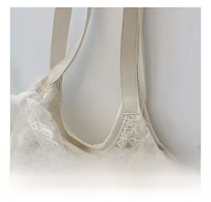 Detail of the white lace crochet tote bag with elegant bow and fine stitching details
