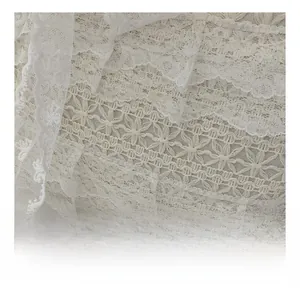 Close-up of white lace embroidery detail with hollow out patterns on a tote bag